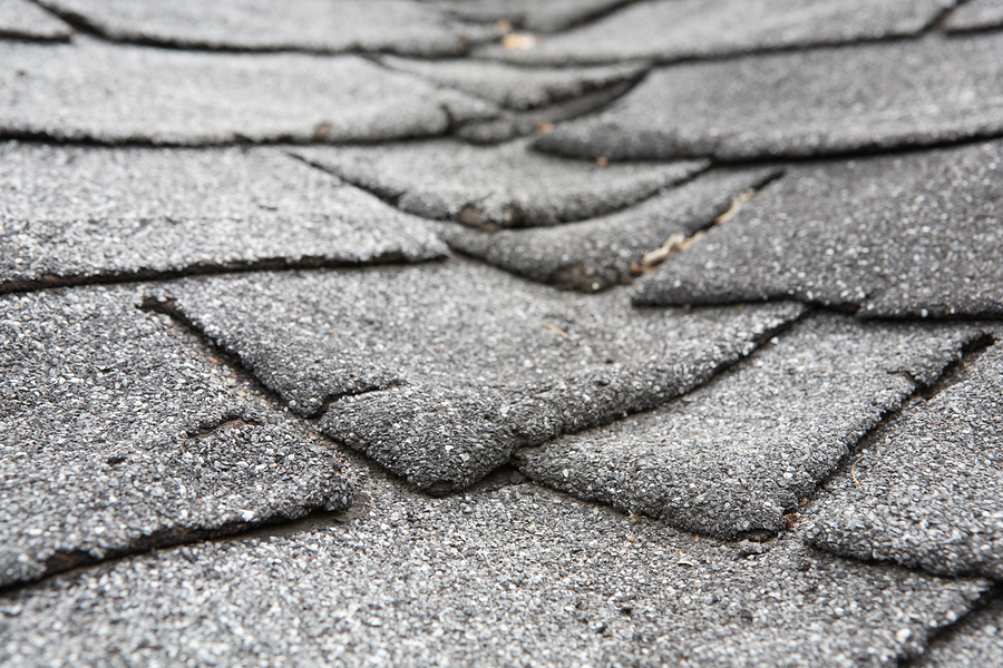 Old composite roof with damage